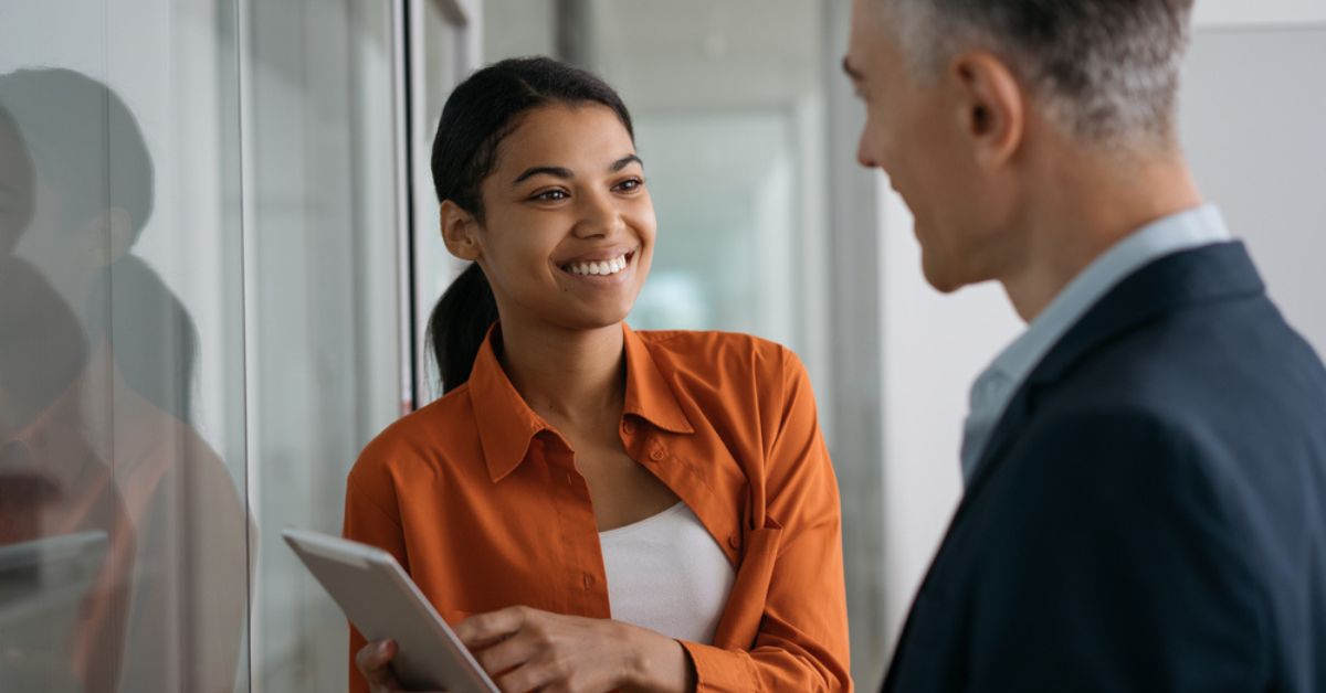 Woman reviewing data on a tablet with another professional