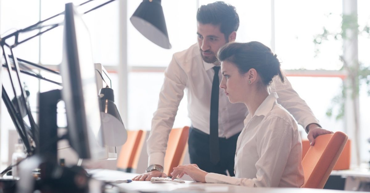 Two people looking at a laptop