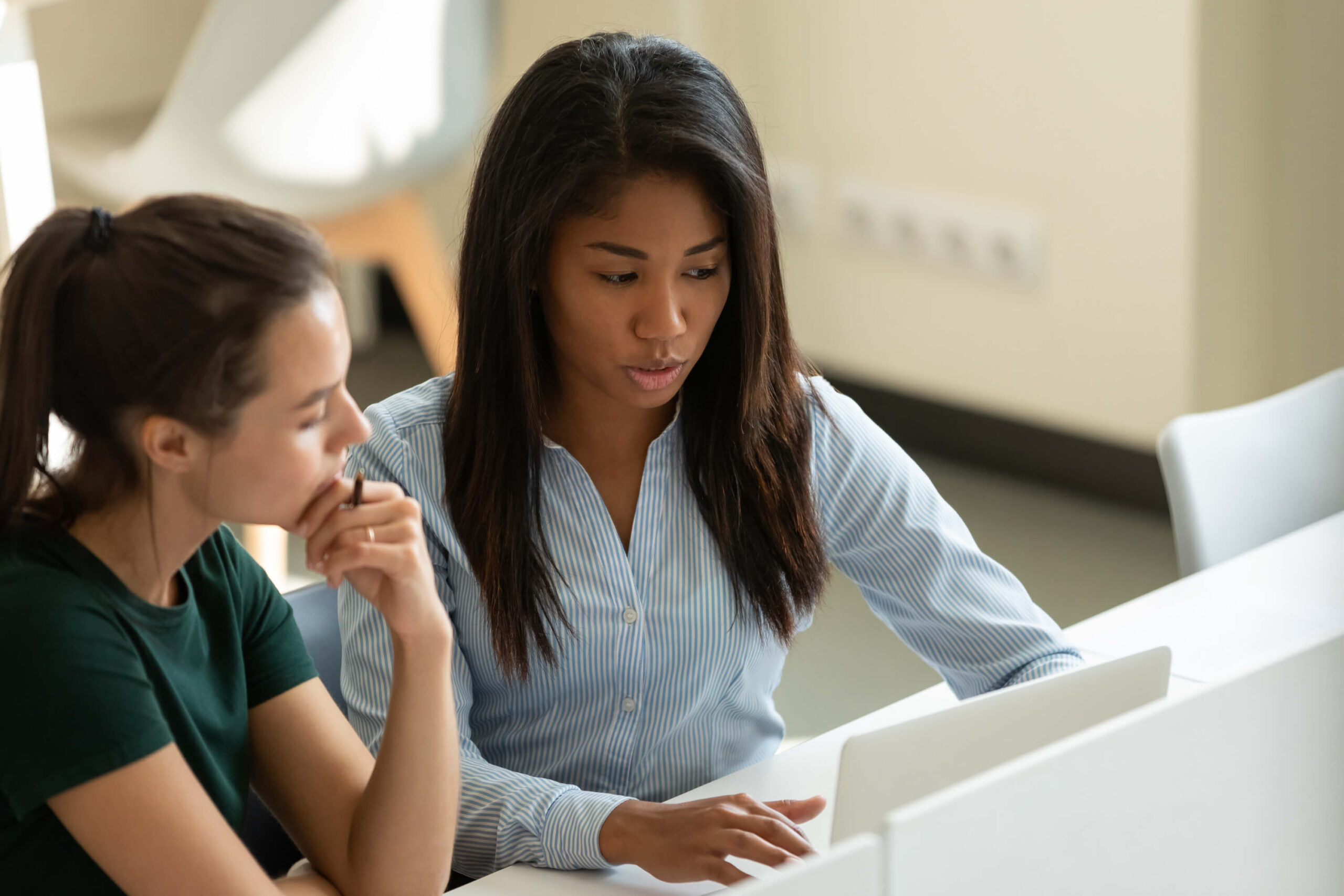 two colleagues working on laptop